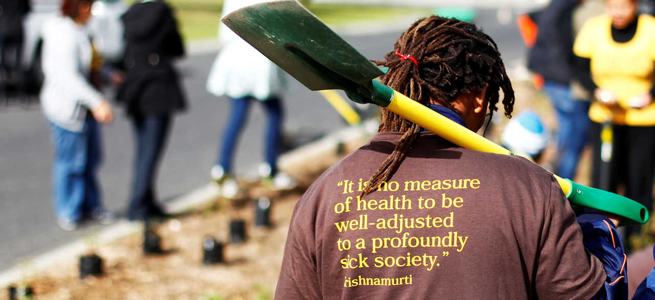 GGHH man with t-shirt reading 'It is no measure of heath to be well-adjusted in a profoundly sick society'
